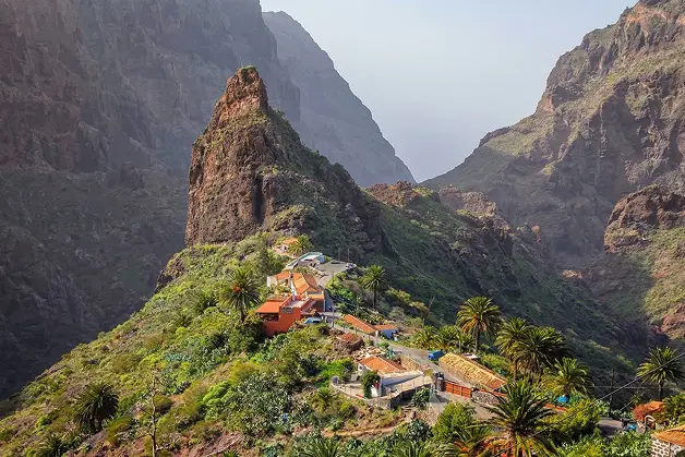 Mountain village of Masca surrounded by dramatic cliffs and lush valley in Tenerife.