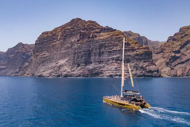 Catamaran sailing past the cliffs of Los Gigantes on the south west coast of Tenerife